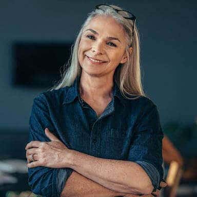 Smiling older woman with arms crossed