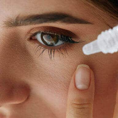 Woman using eye droppers