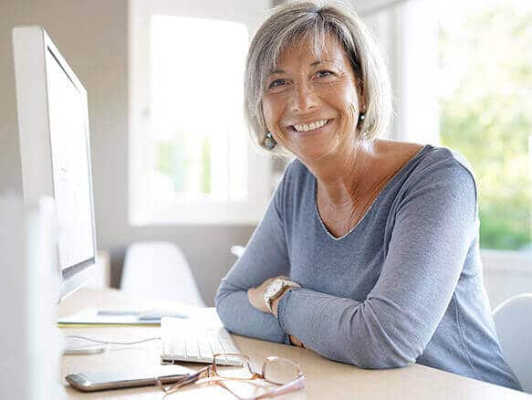 Smiling Woman At Computer