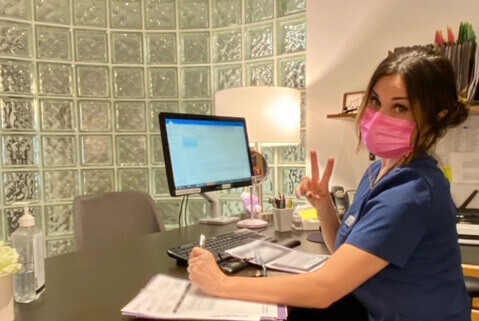 Woman at Desk With Mask